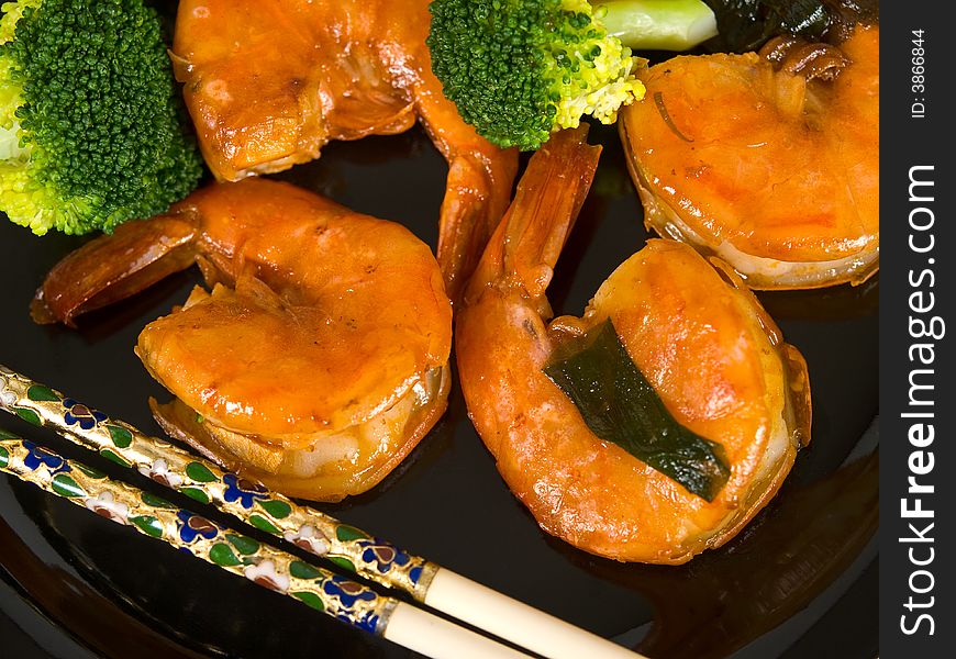 Jumbo Shrimp, Broccoli and chopsticks on a plate. Jumbo Shrimp, Broccoli and chopsticks on a plate