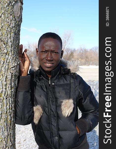 A picture of a African woman in black jacket outdoors