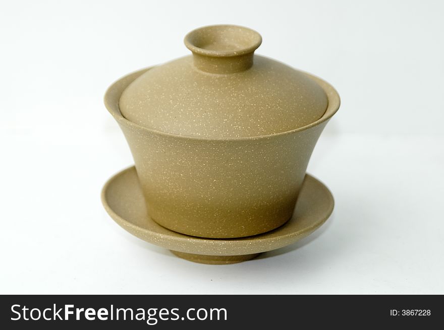 Yellow clay Chinese teacup on white background