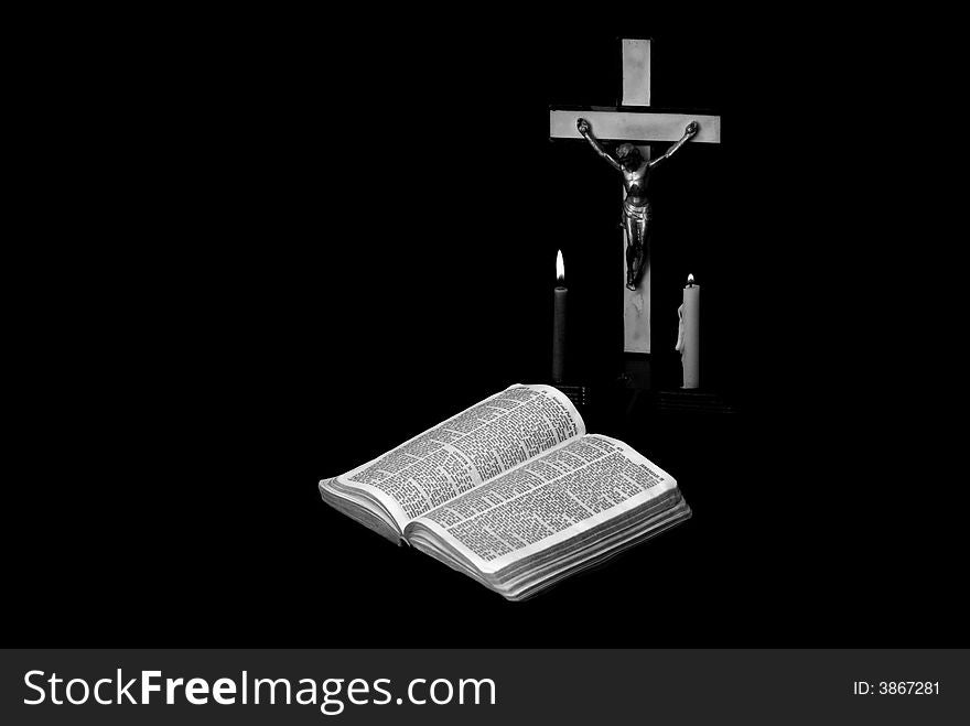 Stark black and white image of a prayer crucifix with two candles set out before a bible open to the book of Jeremiah. Stark black and white image of a prayer crucifix with two candles set out before a bible open to the book of Jeremiah