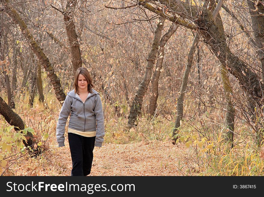 A young girl enjoying a walk in the Autumn woods. A young girl enjoying a walk in the Autumn woods.