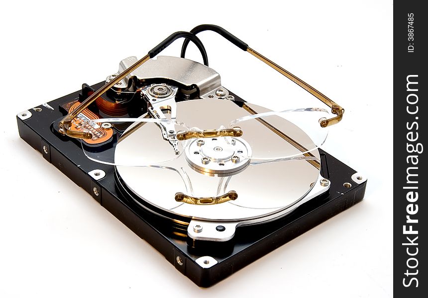 An exposed hard disk drive platter with a pair of glasses on it. An exposed hard disk drive platter with a pair of glasses on it.
