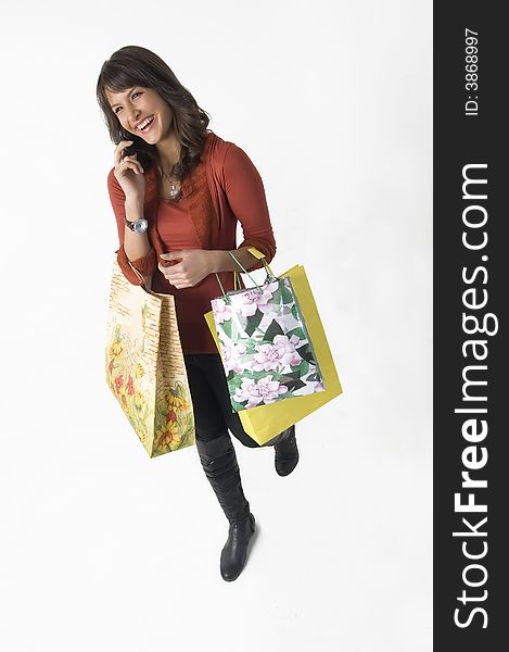 Woman with shopping bags and cellular phone