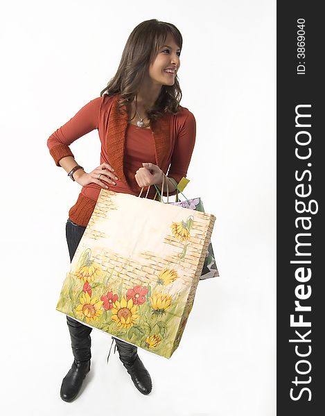 Pretty young woman with green, yellow and beige shopping bags. Pretty young woman with green, yellow and beige shopping bags