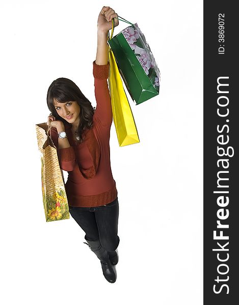 Pretty young woman with green yellow and beige shopping bags. Pretty young woman with green yellow and beige shopping bags