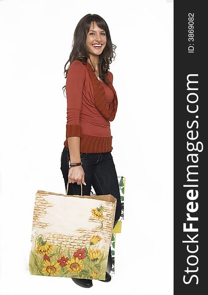 Pretty young woman with green yellow and beige shopping bags. Pretty young woman with green yellow and beige shopping bags