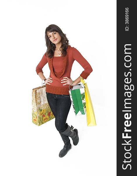 Pretty  young woman with green, yellow and beige shopping bags. Pretty  young woman with green, yellow and beige shopping bags
