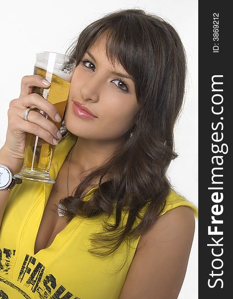 Pretty girl in yellow drinking beer from the glass. Pretty girl in yellow drinking beer from the glass