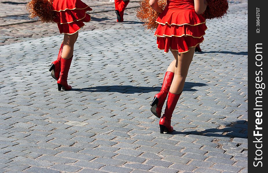 Cheerleaders marching in city street on summer day