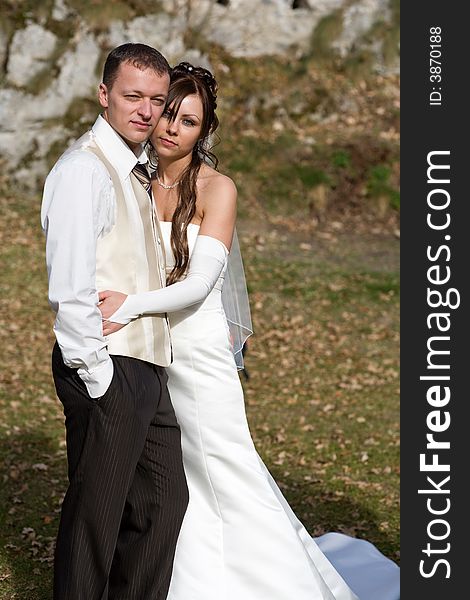 Portrait of an attractive bridal couple outdoors. Portrait of an attractive bridal couple outdoors.