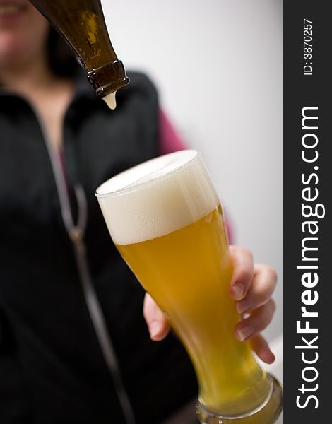 A delicious glass of german Wheat-beer (Weizenbier) is poured in. A delicious glass of german Wheat-beer (Weizenbier) is poured in