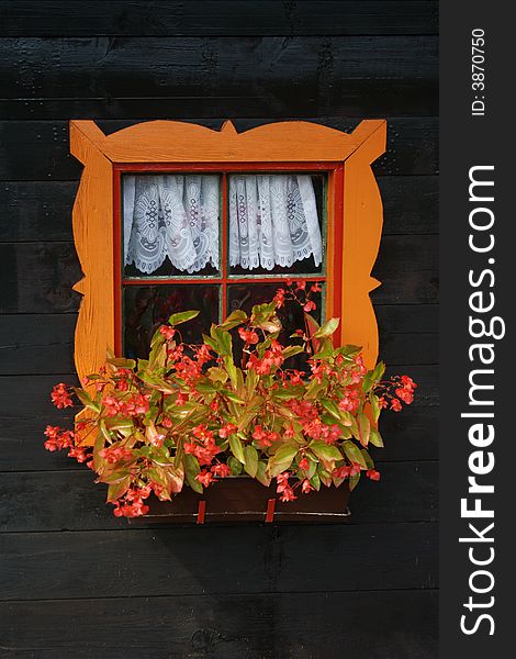 Colourful window with flowers and nice frame.