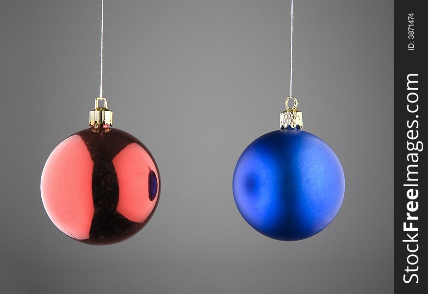 Red and Blue Christmas Baubles against Grey Background. Red and Blue Christmas Baubles against Grey Background