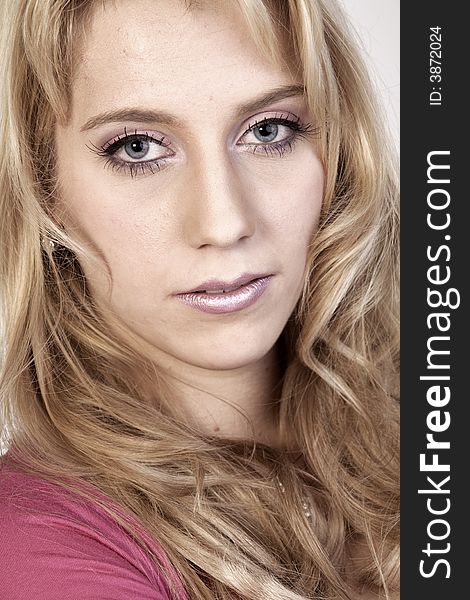 Studio portrait of a long blond girl looking hurt