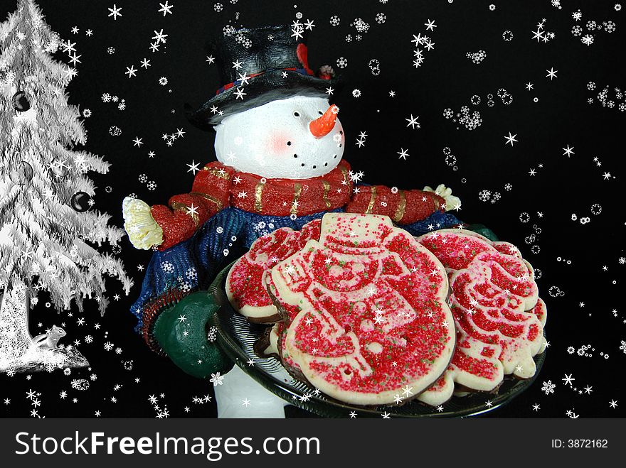 Snowman carrying a plateful of cookies in the snow. Snowman carrying a plateful of cookies in the snow.