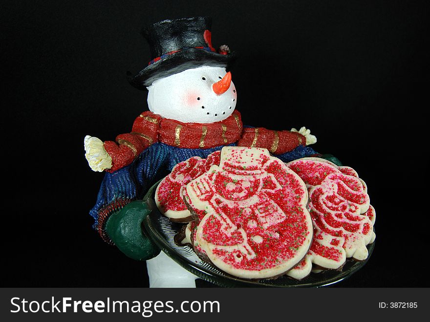 Isolated snowman delivering a plate of cookies. Isolated snowman delivering a plate of cookies.