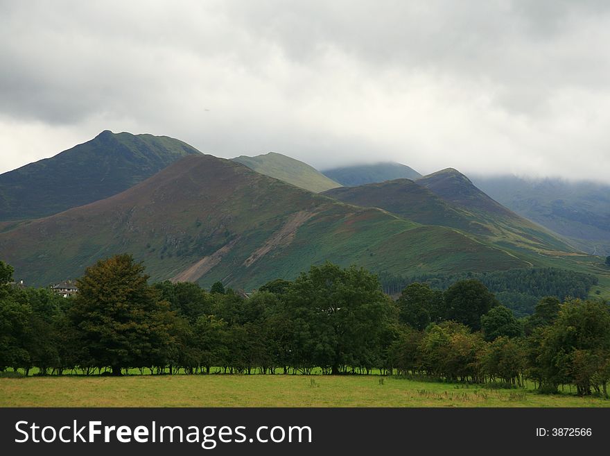 Hills in a landscape photo covered in cloud. Hills in a landscape photo covered in cloud