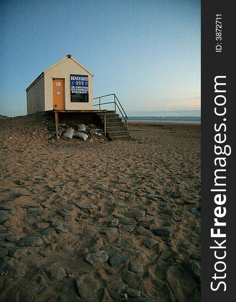A beach hut alone on a beach