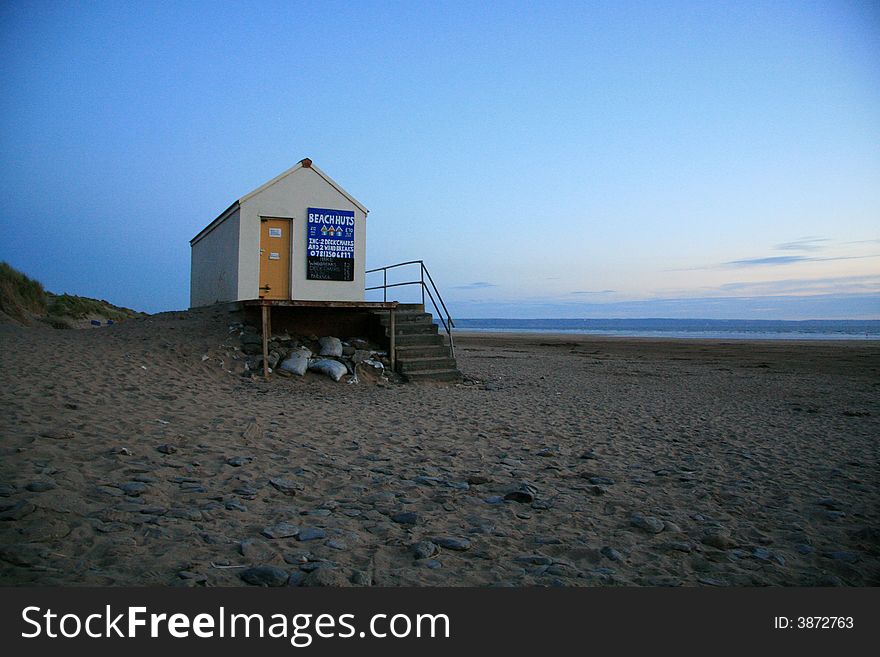 A beach hut alone on a beach