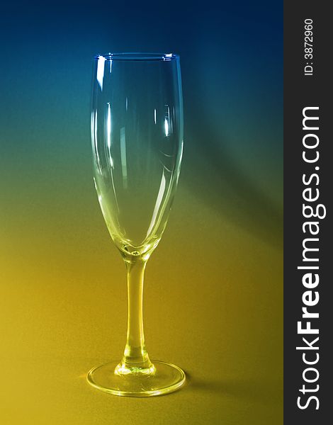 Empty champagne glass toned in blue and yellow. Empty champagne glass toned in blue and yellow