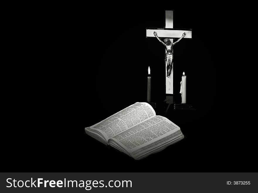 Stark black and white image of a prayer crucifix with two candles set out before a bible open to the book of Jeremiah. Stark black and white image of a prayer crucifix with two candles set out before a bible open to the book of Jeremiah