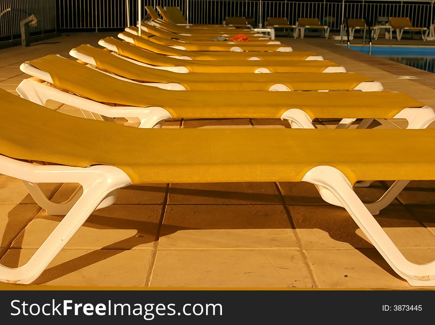 Row of sunbeds by the pool