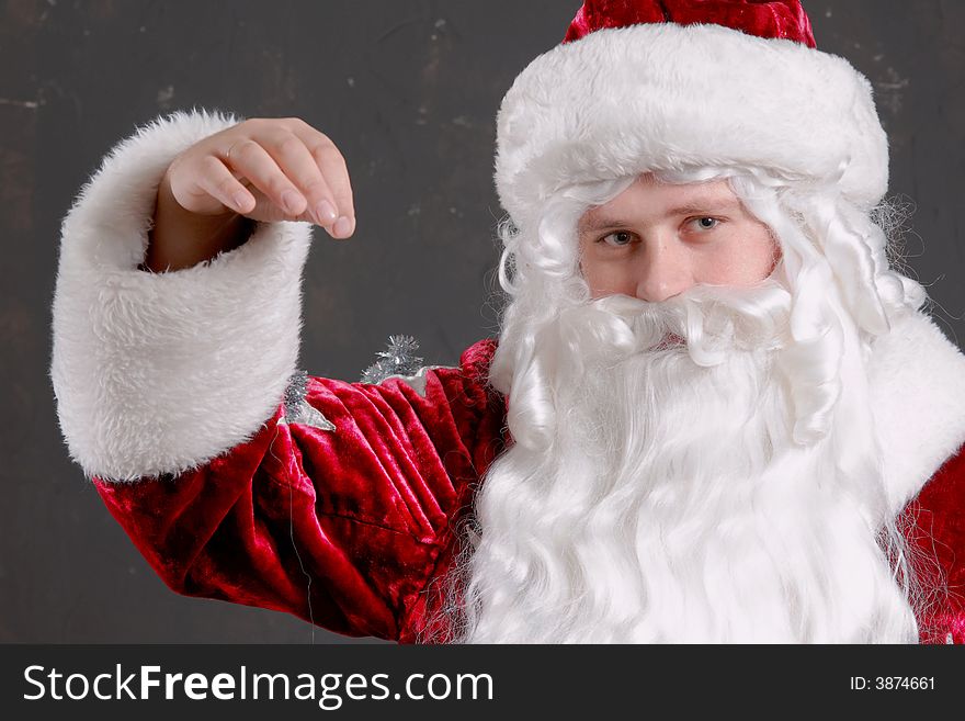 Santa Claus showing onto a red mitten. Santa Claus showing onto a red mitten