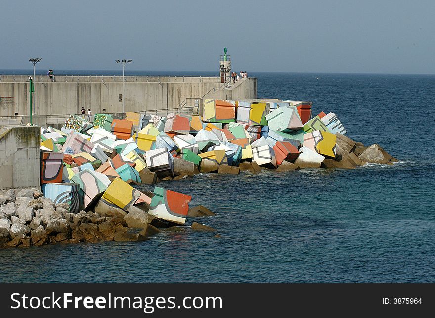 A great peaces of stone on a seaside built to break waves. A great peaces of stone on a seaside built to break waves