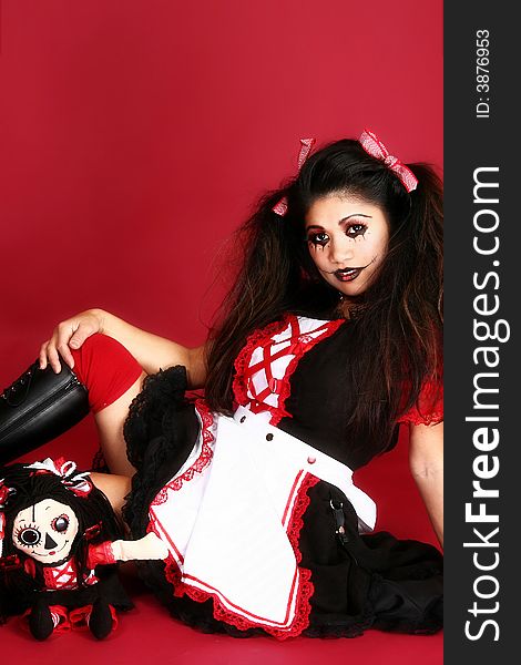 Beautiful Filipino woman dressed as doll over red background. Beautiful Filipino woman dressed as doll over red background.