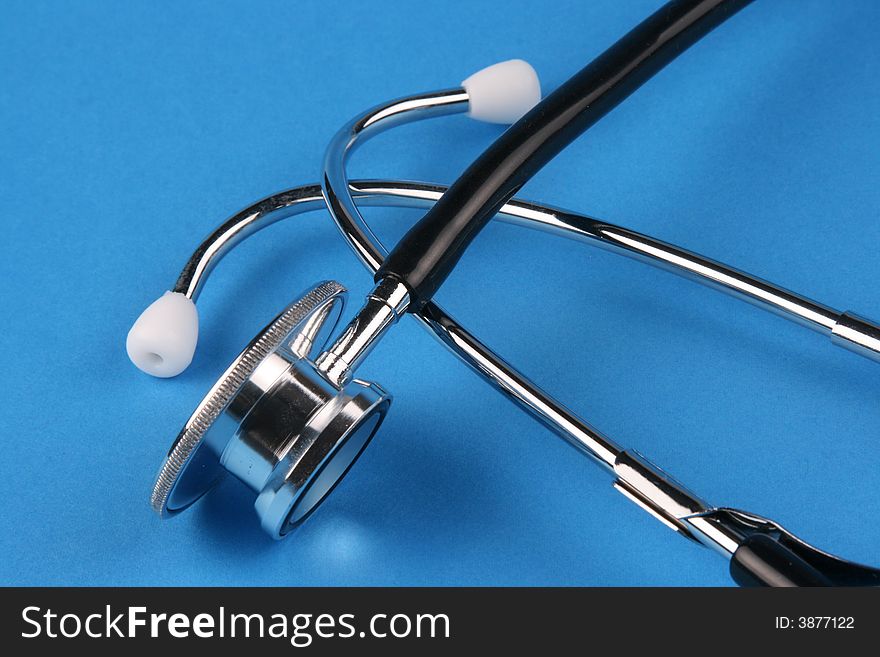 A stethoscope in plain blue background.