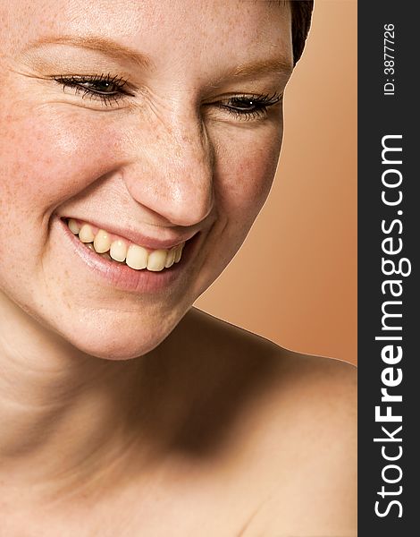 Studio portrait of a young woman with short hair in laughs