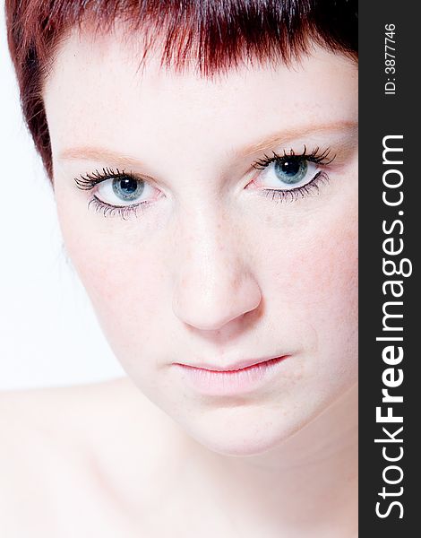 Studio portrait of a young woman with short hair making eye contact