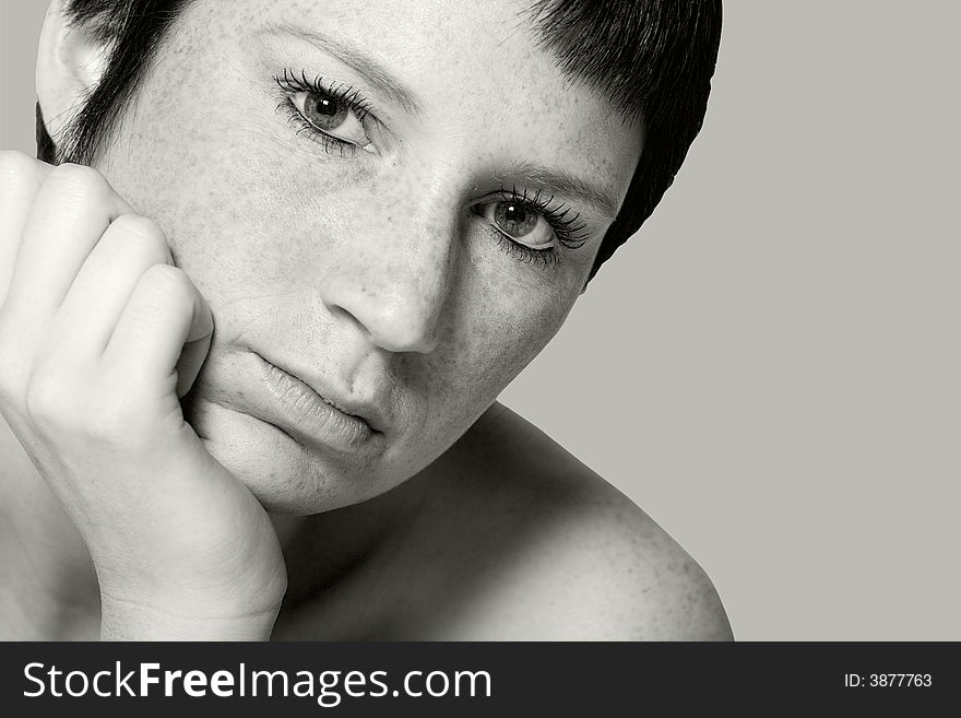 Studio portrait of a young woman with short hair looking bored. Studio portrait of a young woman with short hair looking bored