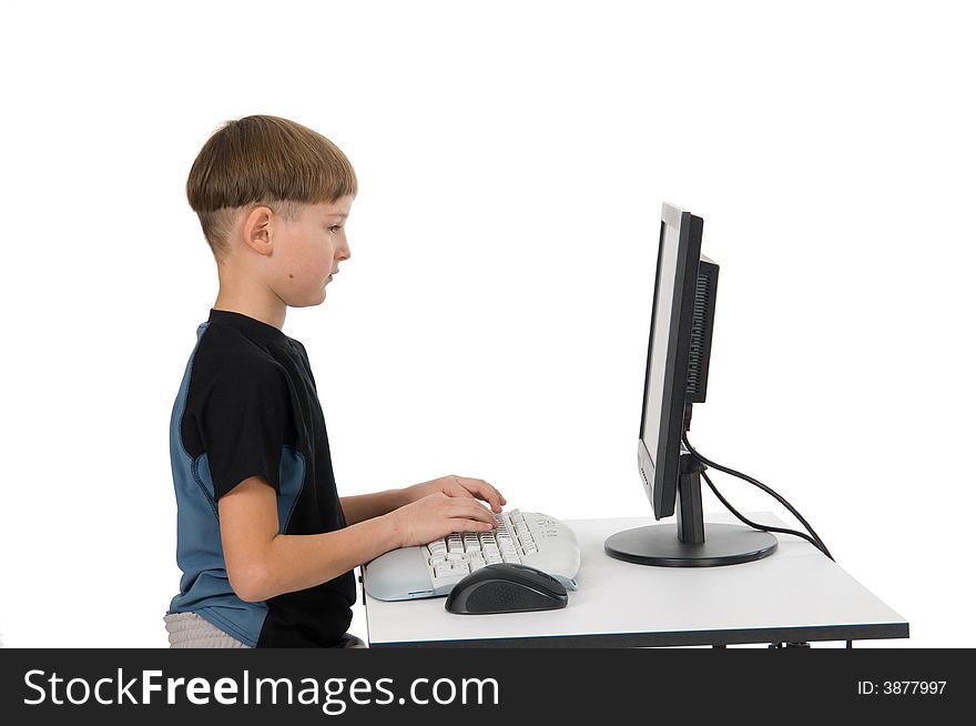 Boy on computer with cordless mouse and keyboard. Boy on computer with cordless mouse and keyboard.