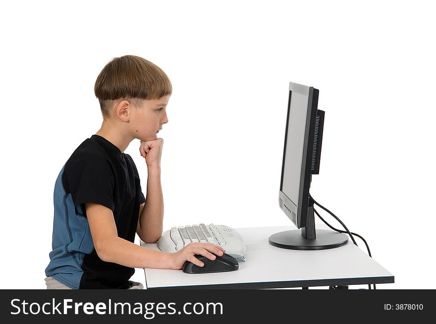 Boy on computer with cordless mouse and keyboard thinking. Boy on computer with cordless mouse and keyboard thinking.