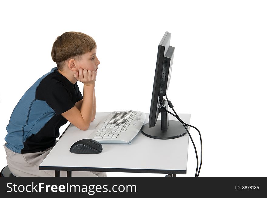 Boy on computer with cordless mouse and keyboard thinking. Boy on computer with cordless mouse and keyboard thinking.