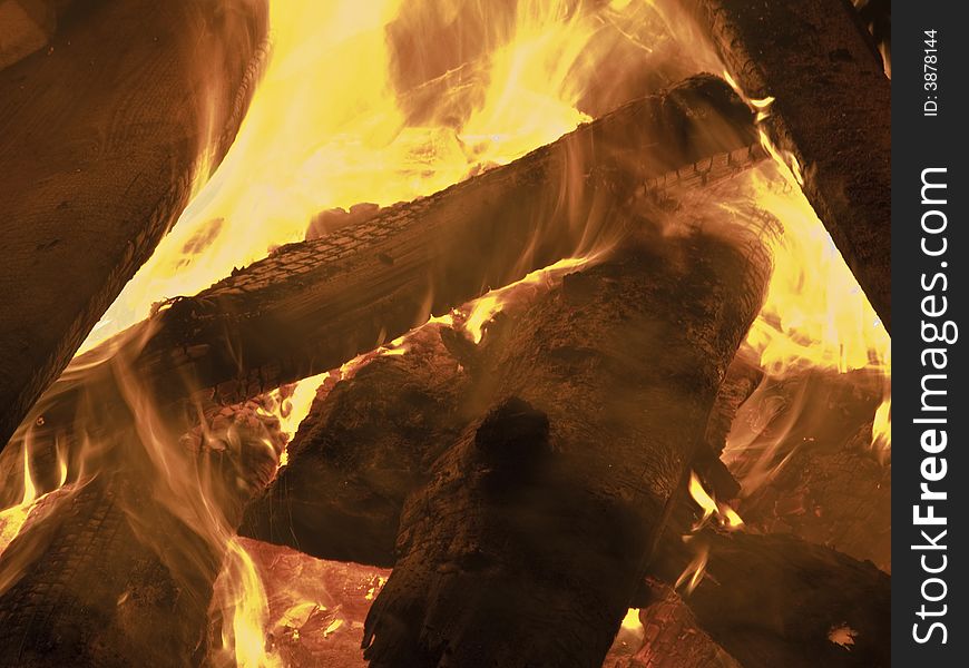 Detail of outdoor bonfire with burning logs generating heat