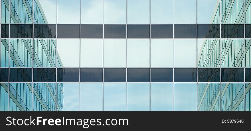 Reflections of surrounding buildings in a glass front