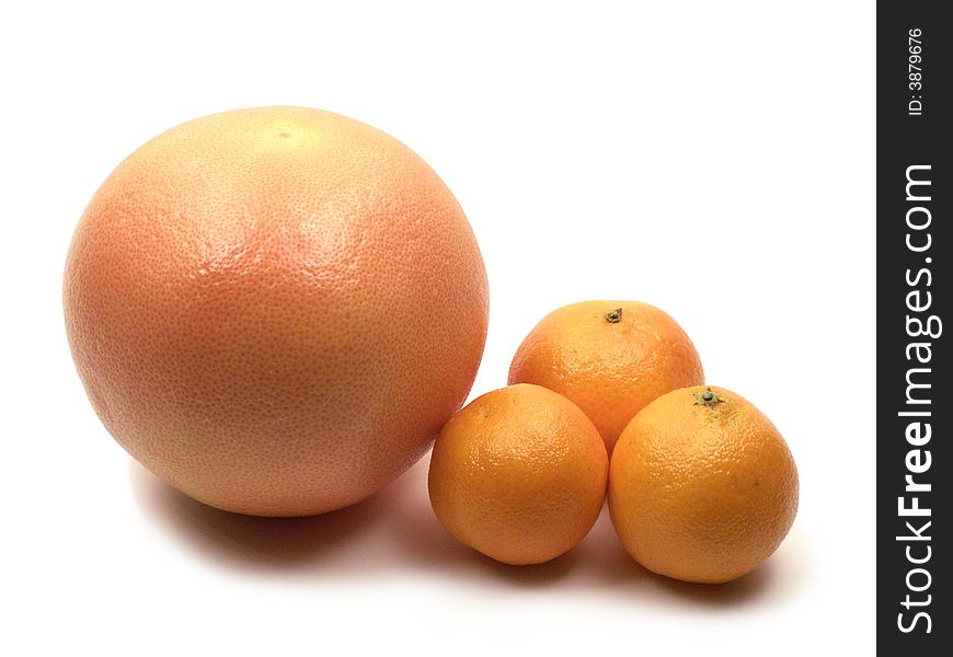 One grapefruit and three tangerines on white background. One grapefruit and three tangerines on white background