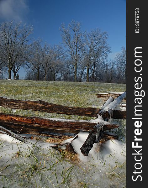 And old fashioned wood fence covered in ice during winter on a cold December day. And old fashioned wood fence covered in ice during winter on a cold December day.