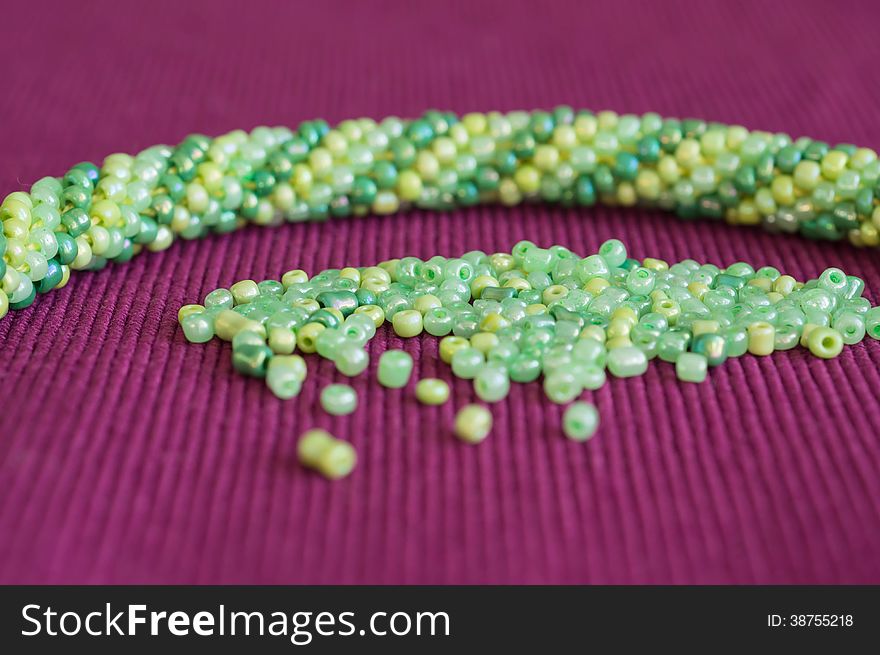 Knitted necklace and the scattered beads close up