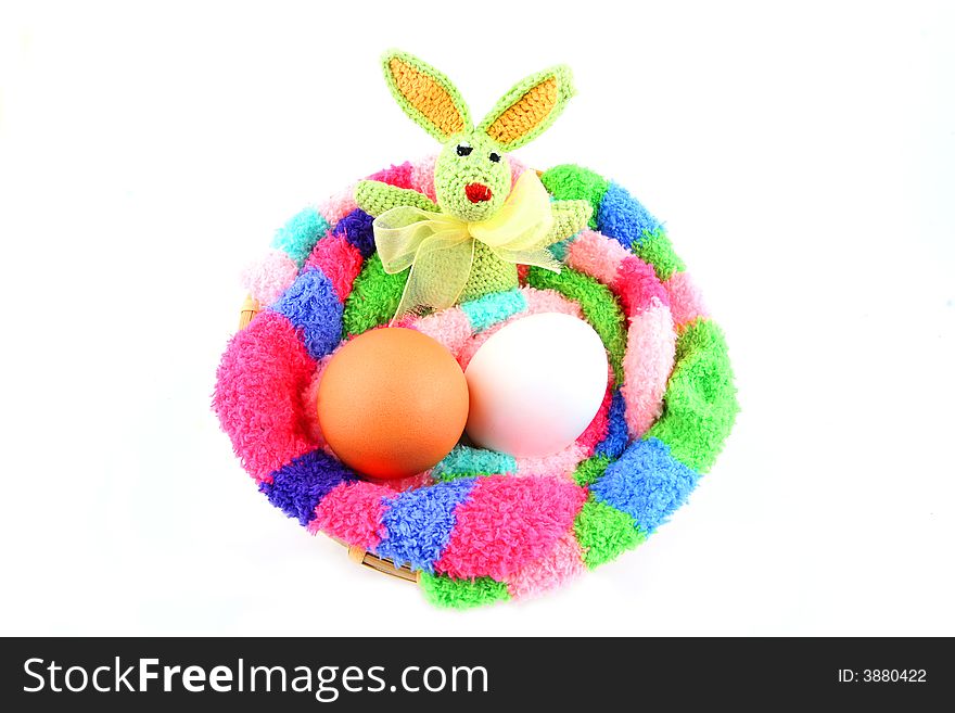 Easter bunny and two eggs in a fluffy multicolored clutch. Easter bunny and two eggs in a fluffy multicolored clutch