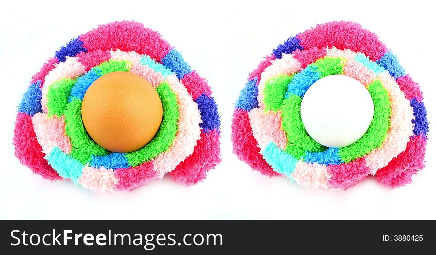 Two eggs in a multicolored fluffy easter clutches. Two eggs in a multicolored fluffy easter clutches