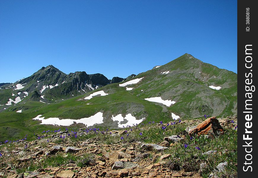 Triangle mountains with snow pieces