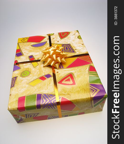 Gift in box packed into bright color paper on white background