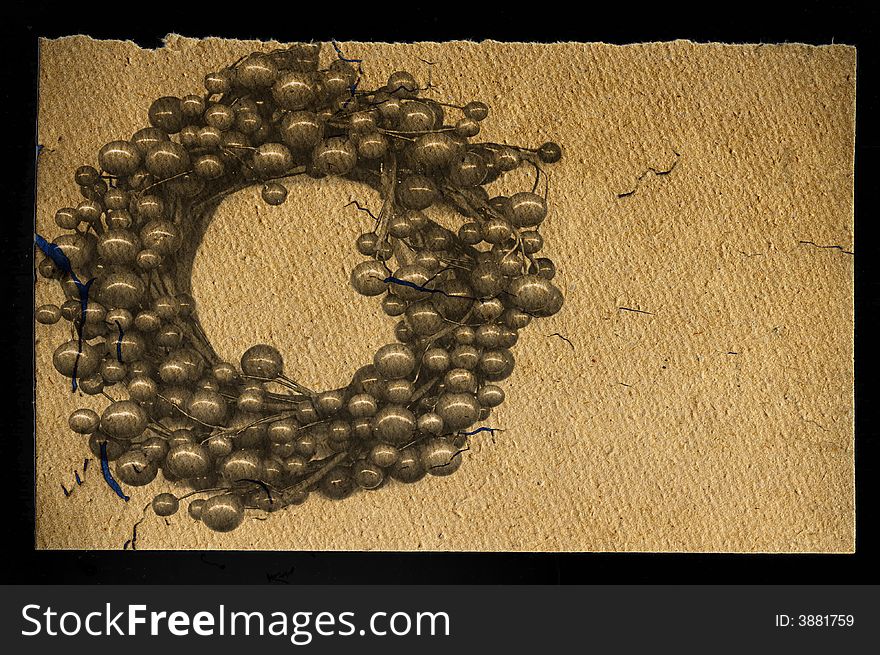 Old handmade paper texture with crown berries. Old handmade paper texture with crown berries