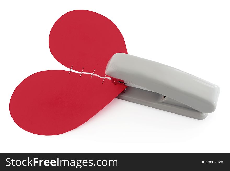 Two halves of red heart and stapler isolated on white background