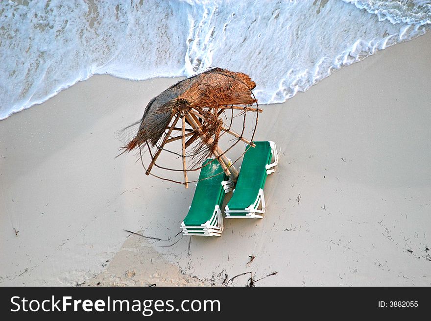 Broken umbrella and beach chairs