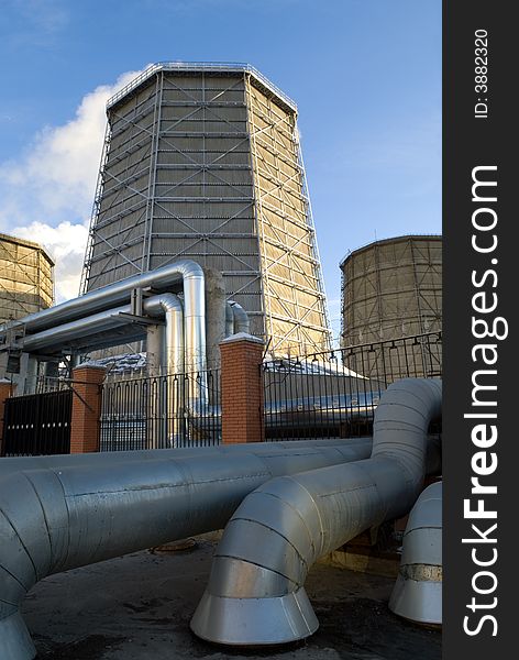 Electric power station chimneys over blue sky