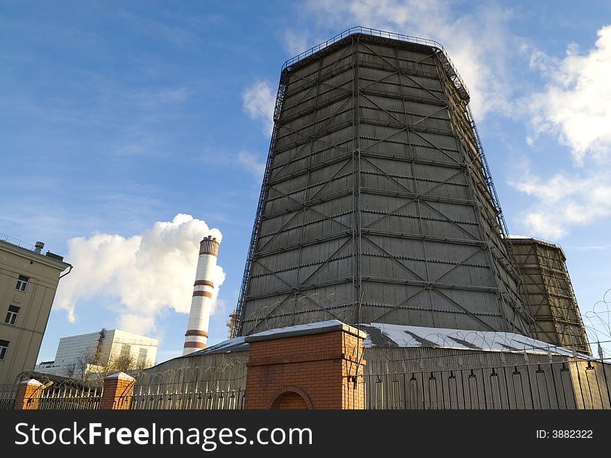 Electric power station chimneys over blue sky